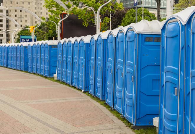 a line of portable restrooms at a sporting event, providing athletes and spectators with clean and accessible facilities in Guilderland Center NY